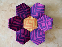 http://www.patchworkposse.com/how-to-sew-a-hexagon-flower/