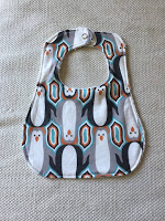 http://www.marymarthamama.com/crafty-cat/baby-bib-tutorial-with-free-printable-pattern/