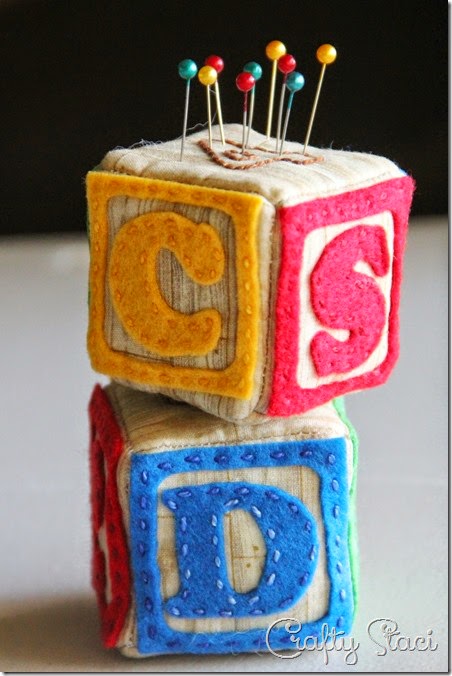 http://craftystaci.com/2015/03/04/alphabet-block-pincushion/