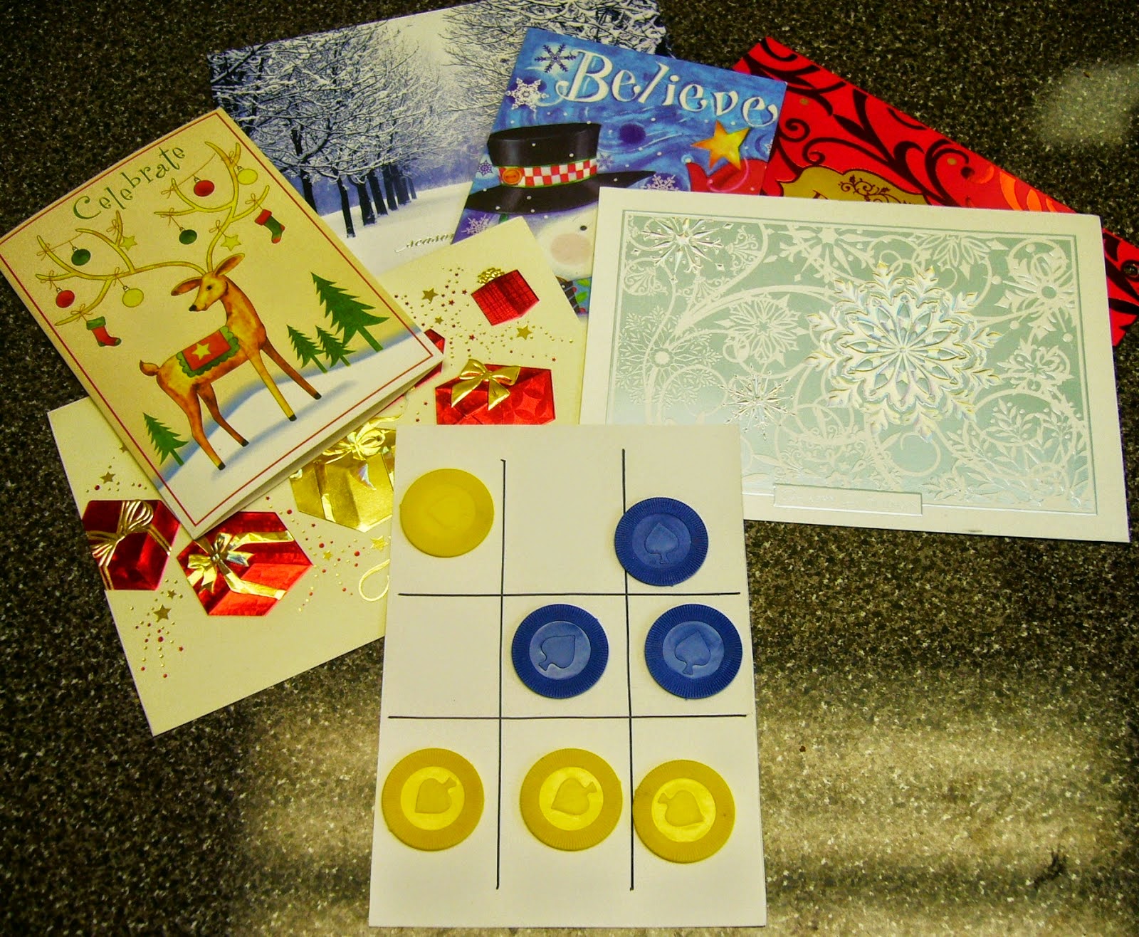 http://www.simplyshoeboxes.com/2015/02/tic-tac-toe-game-from-upcycled-greeting.html