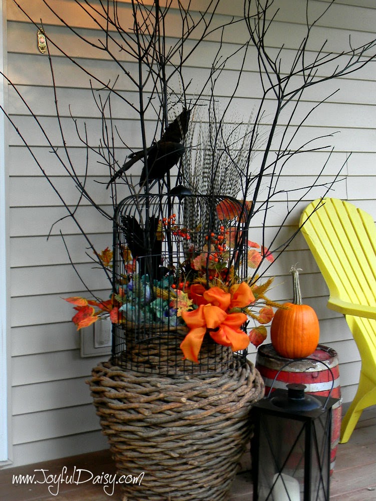 http://joyfuldaisy.com/fall-porch-decorations-birdcage-twig-urn/